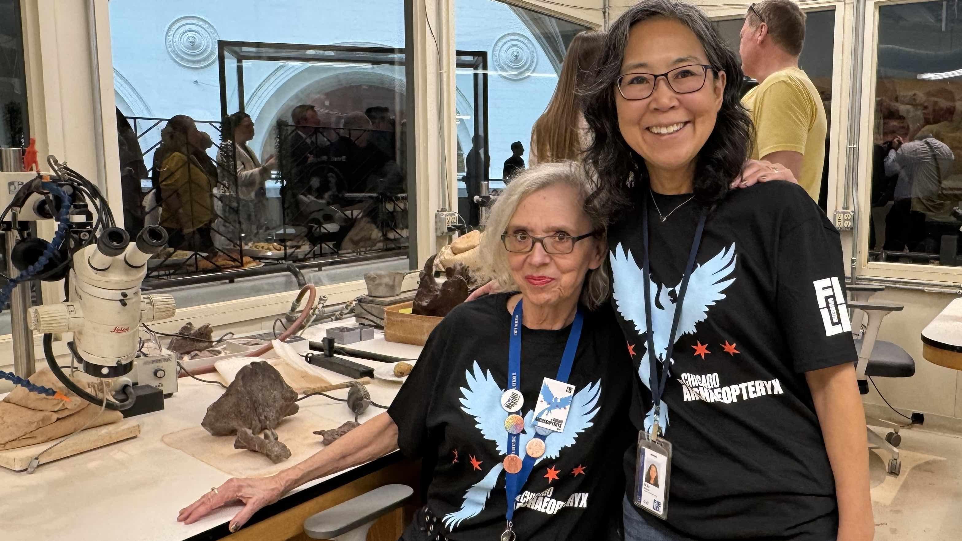Connie Van Beek, left, and Akiko Shinya celebrated the reveal of the Chicago Archaeopteryx. The two spent a collective 1,200 preparing the fossil, revealing intricate detail formerly hidden in rock. (Patty Wetli / WTTW News) 