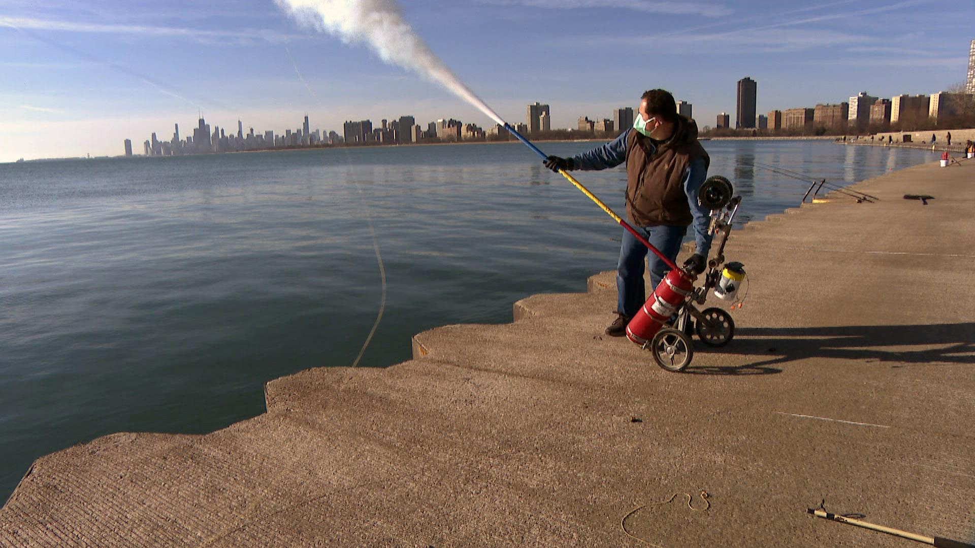 Florin Deleanu propels a fishing line into the air with the carbon dioxide burst of a fire extinguisher on Mar. 12, 2021, at Montrose Harbor. (WTTW News)