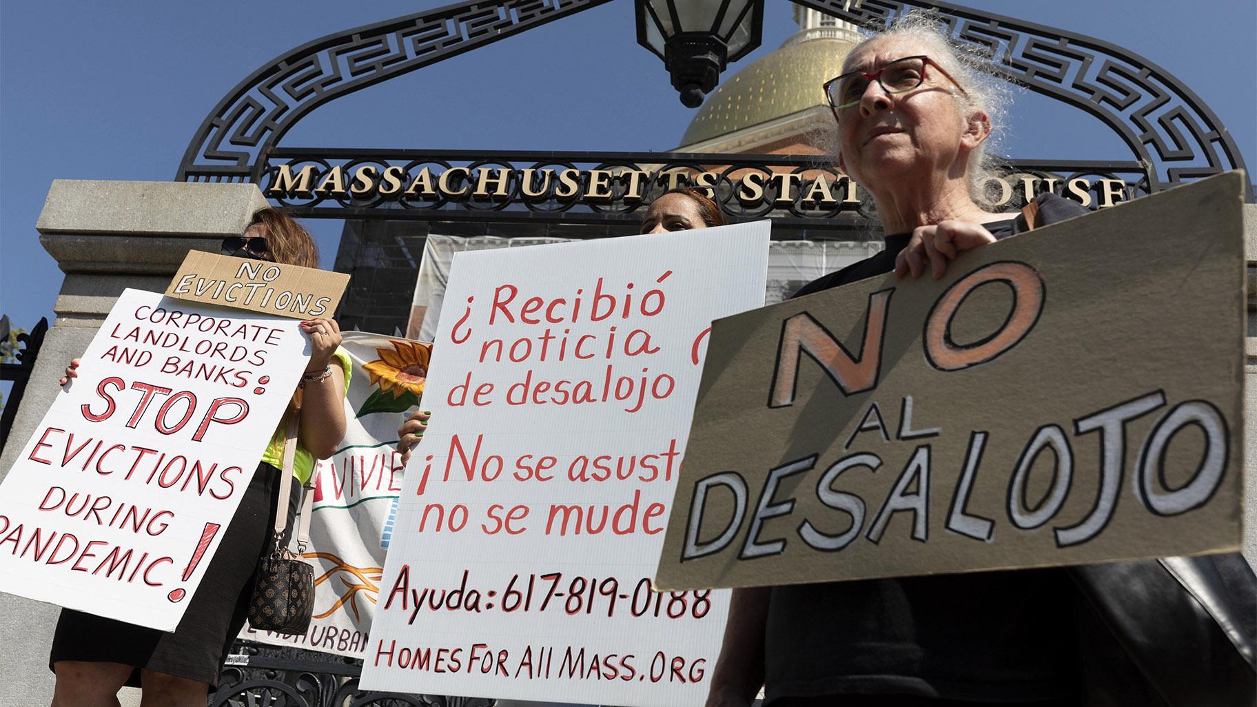 People from a coalition of housing justice groups hold signs protesting evictions during a news conference outside the Statehouse, Friday, July 30, 2021, in Boston. (AP Photo / Michael Dwyer)