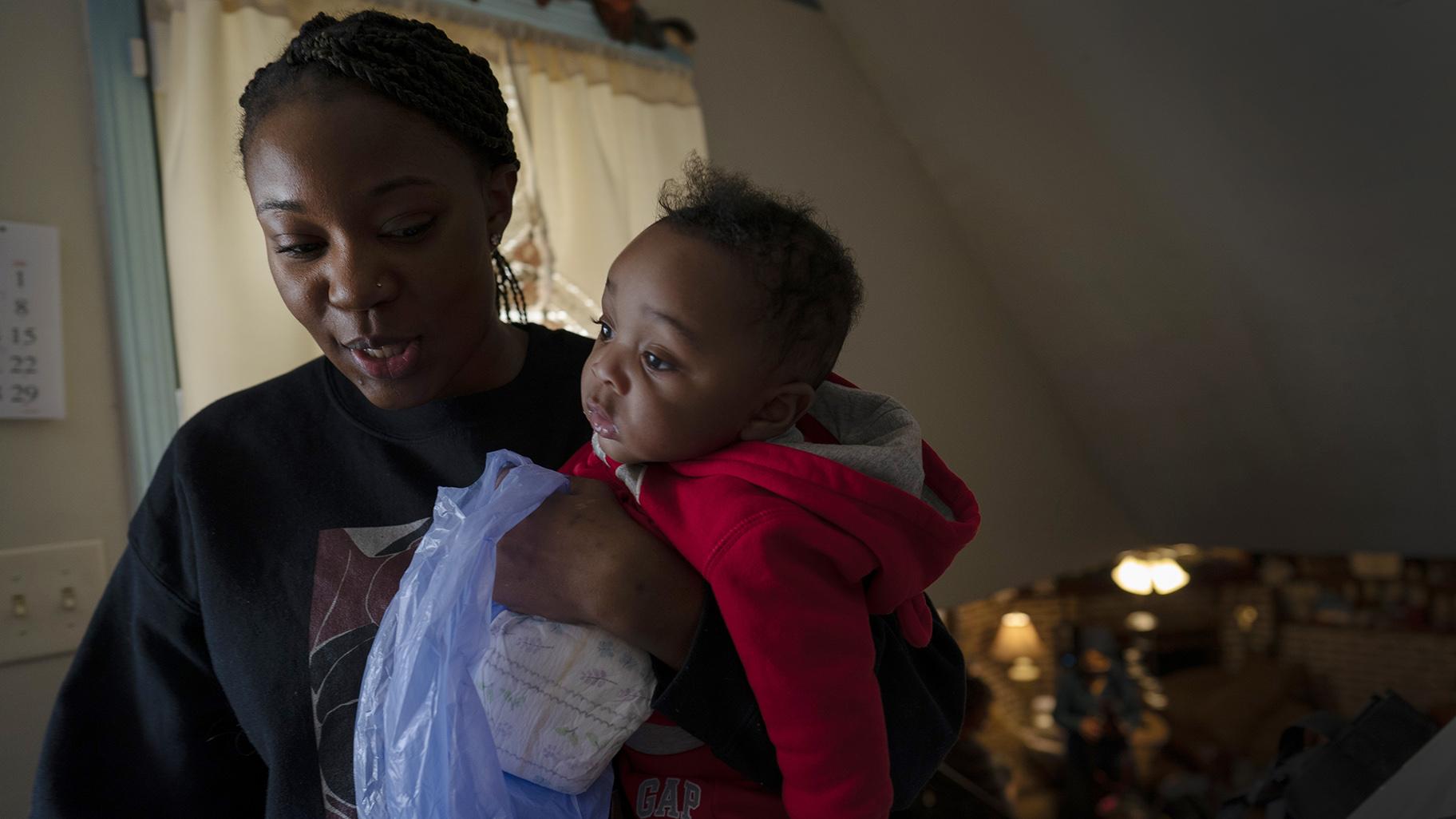 Ansonia Lyons carries her son, Adrien Lyons, as she takes him for a diaper change in Birmingham, Ala., on Saturday, Feb. 5, 2022. After two miscarriages, Ansonia became pregnant in 2020, and it was difficult. (AP Photo / Wong Maye-E, File)