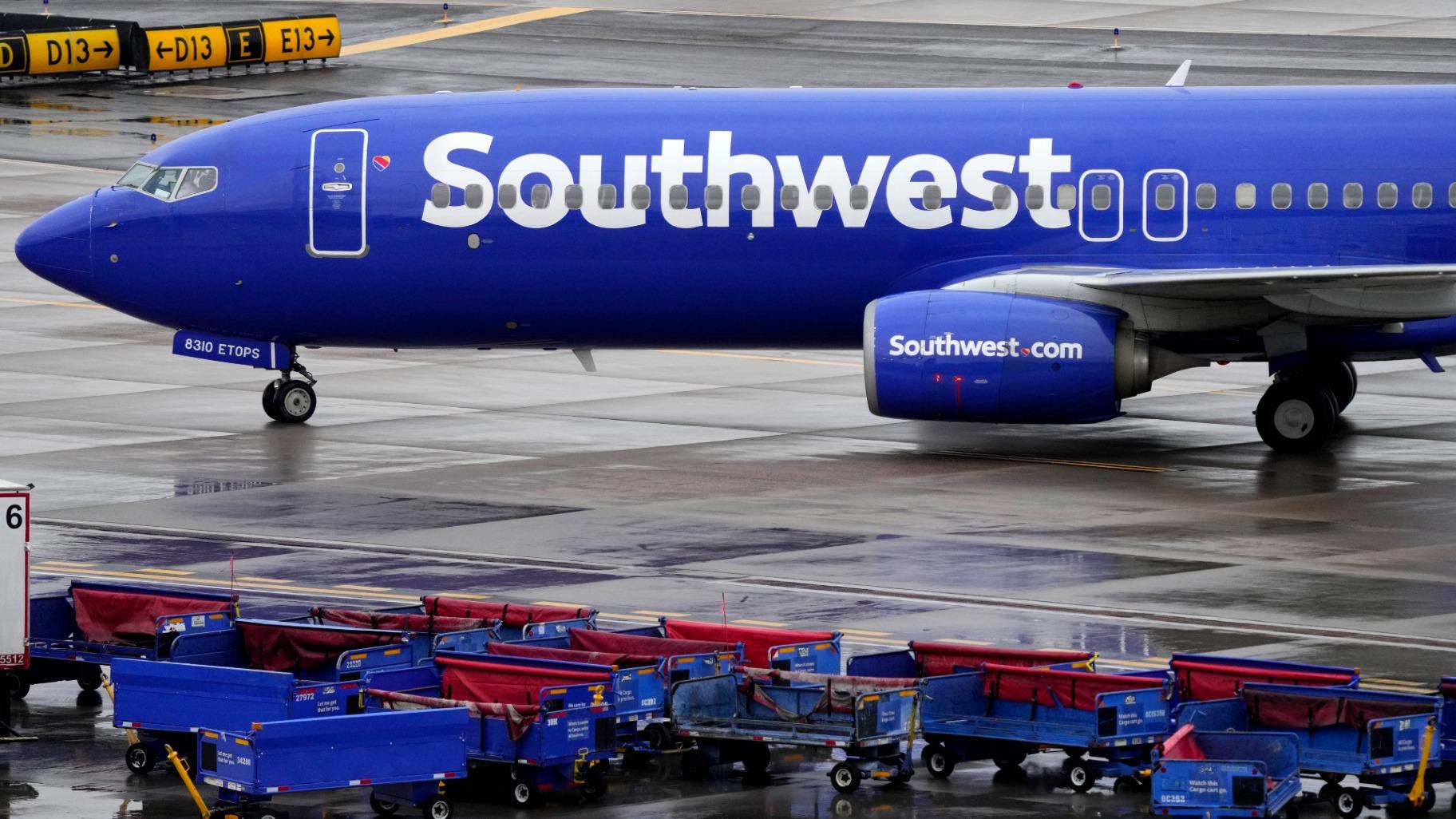FILE - A Southwest Airlines jet passes unused luggage carts as it arrives, Dec. 28, 2022, at Sky Harbor International Airport in Phoenix. (AP Photo / Matt York, File)