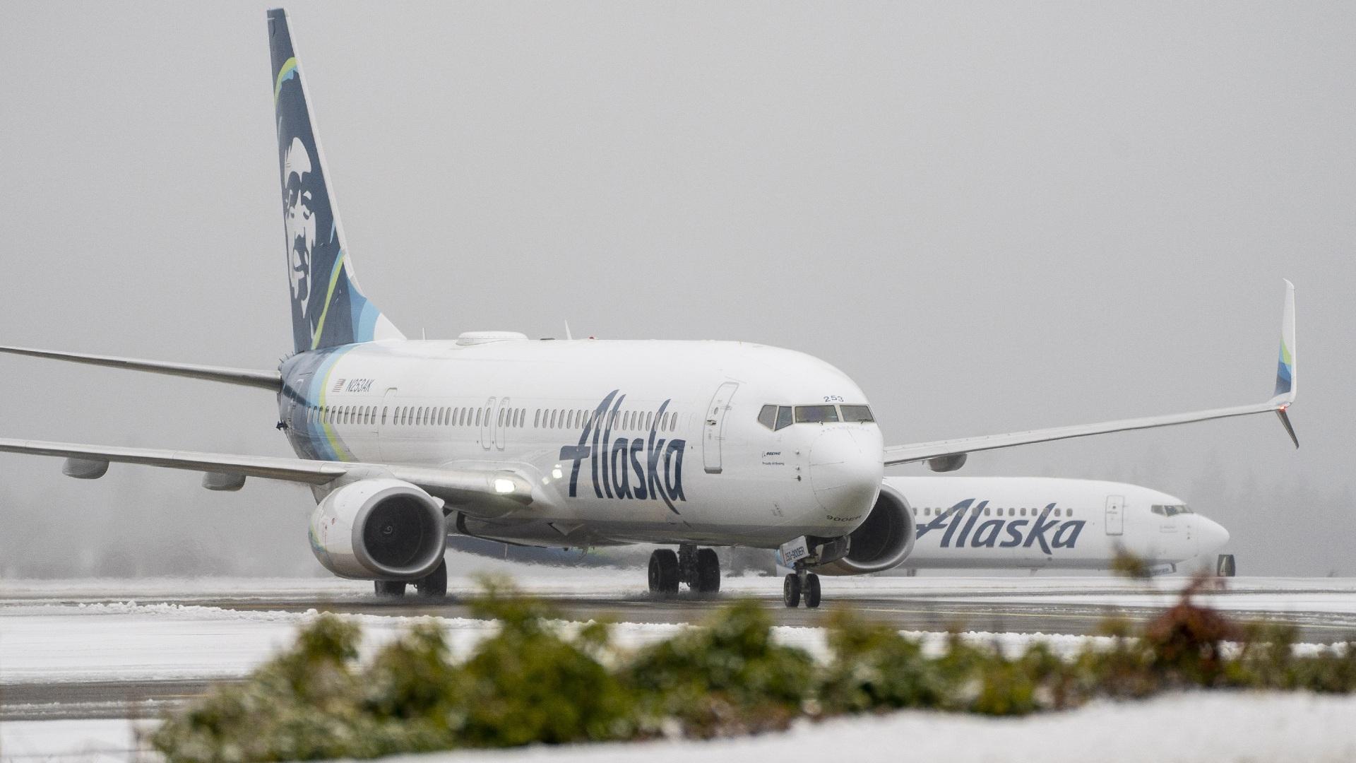 More than 1,000 flights have been cancelled across the United States, according to the flight tracking site FlightAware, as severe winter weather threatens holiday travel, and pictured, Alaska Airlines planes in Seattle, Washington, on Dec. 20. (David Ryder / Bloomberg / Getty Images)