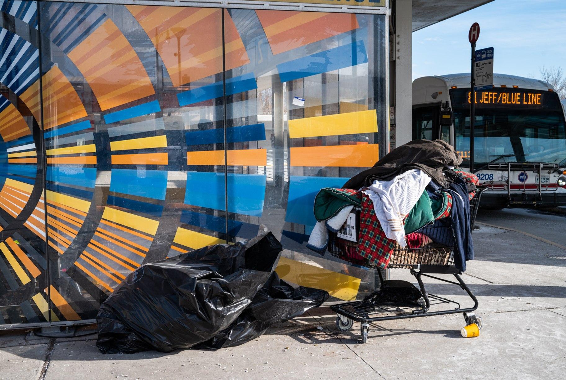 A homeless person’s belongings sit in a shopping cart and trash bag at the Jefferson Park Blue Line station on Jan. 31, 2023. (Colin Boyle / Block Club Chicago)