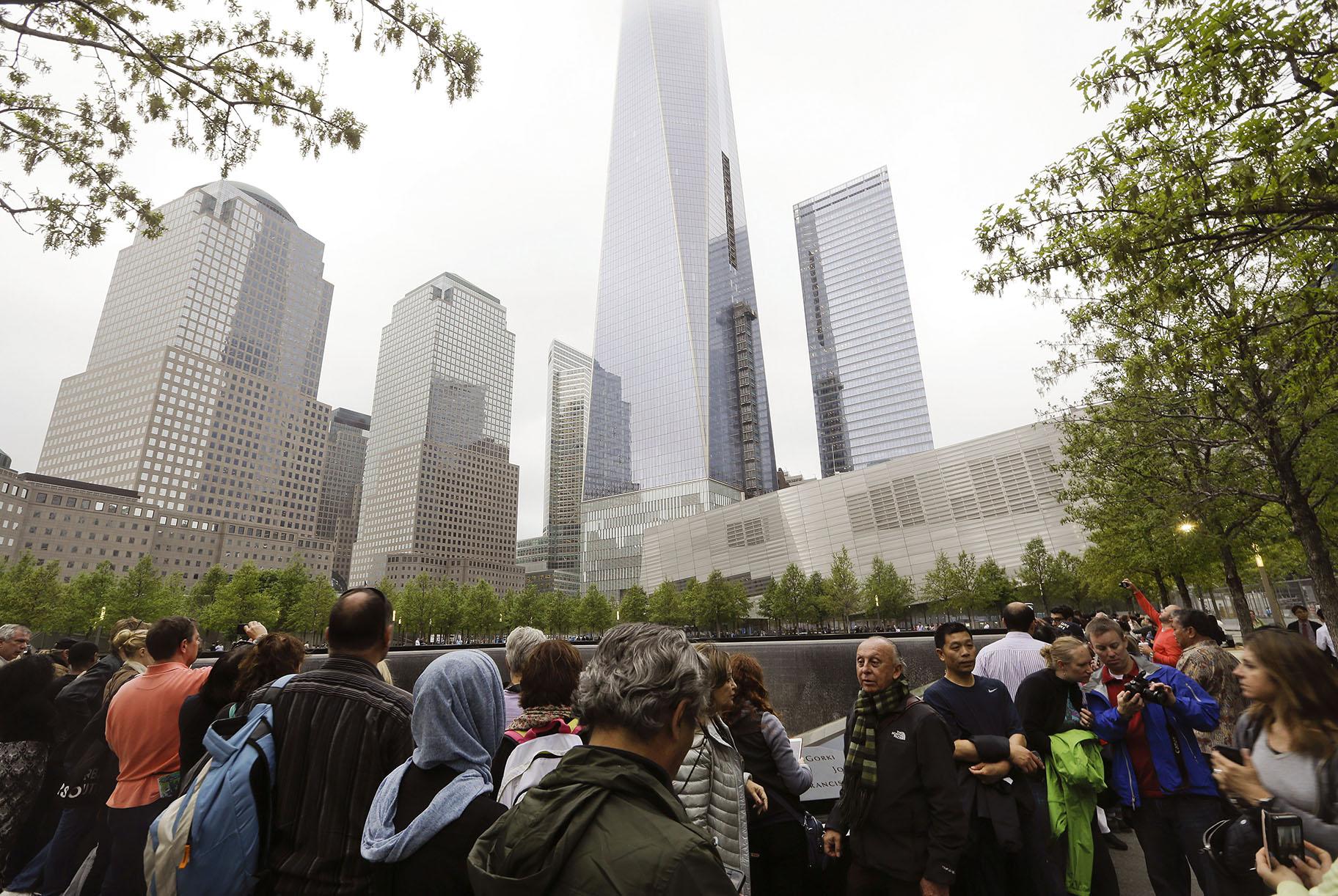 In this May 15, 2015 file photo, visitors gather near the pools at the 9/11 Memorial in New York. As they have done 17 times before, a crowd of victims' relatives is expected at the site on Wednesday, Sept. 11, 2019 to observe the anniversary the deadliest terror attack on American soil. (AP Photo / Frank Franklin II)