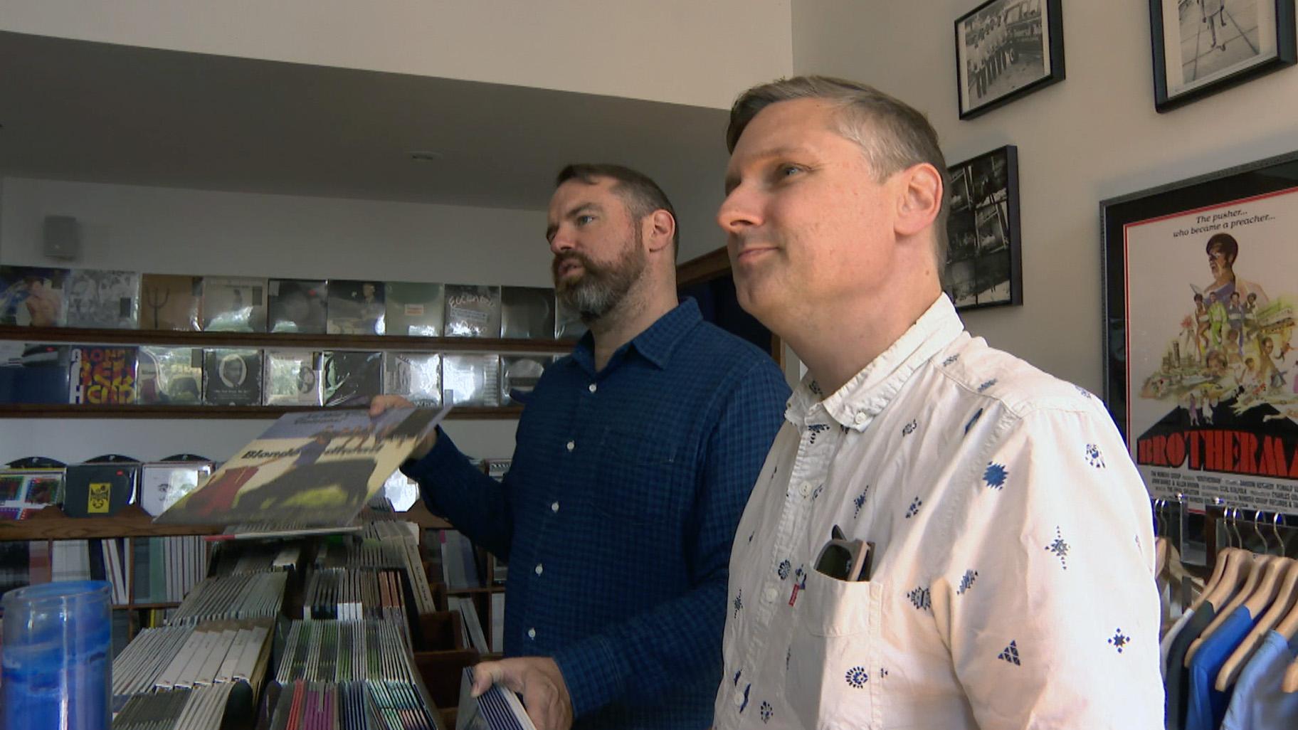 Numero Group co-founders Rob Sevier, left, and Ken Shipley, right, in their record label's shop on July 29, 2021. (WTTW News)