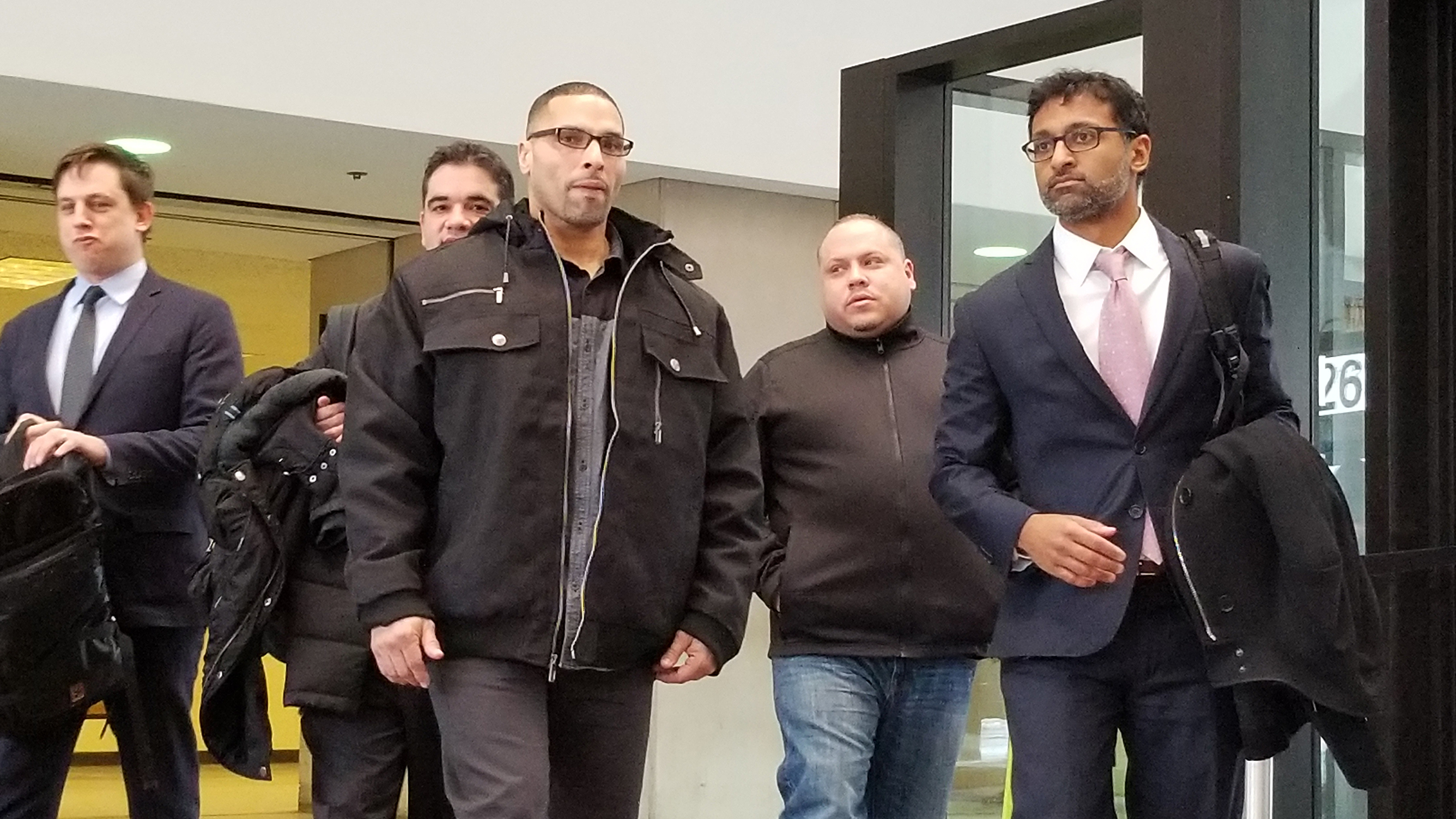 Thomas Sierra, center, exits the George N. Leighton Criminal Courthouse. Murder charges levied against him were dropped on Tuesday after he spent 22 1/2 years in prison. (Matt Masterson / Chicago Tonight)