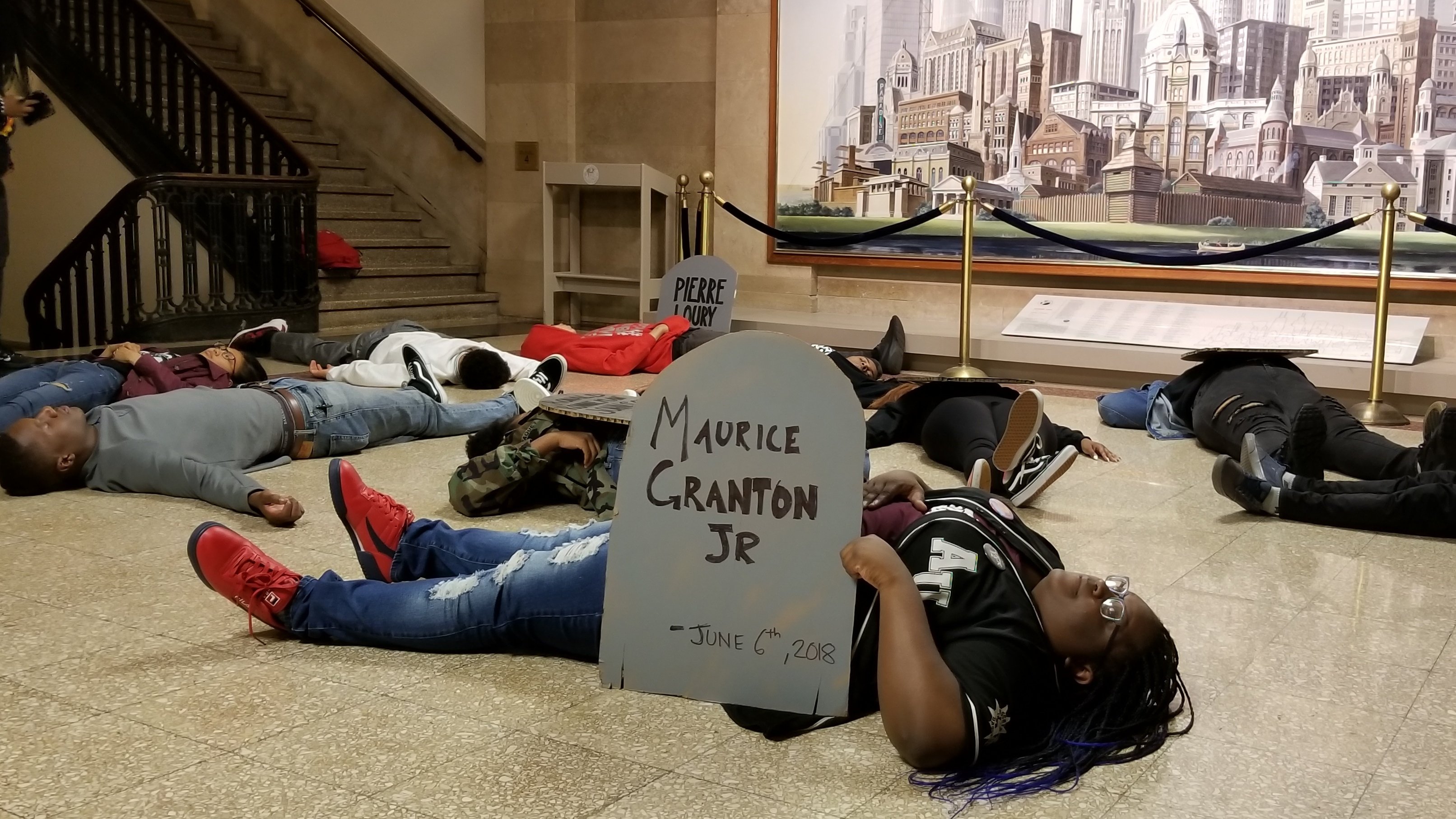 Chicago teens hold a three-minute “die-in” at City Hall on Monday, June 11 in remembrance of Maurice Granton Jr. and others killed by the Chicago Police Department. (Matt Masterson / Chicago Tonight)