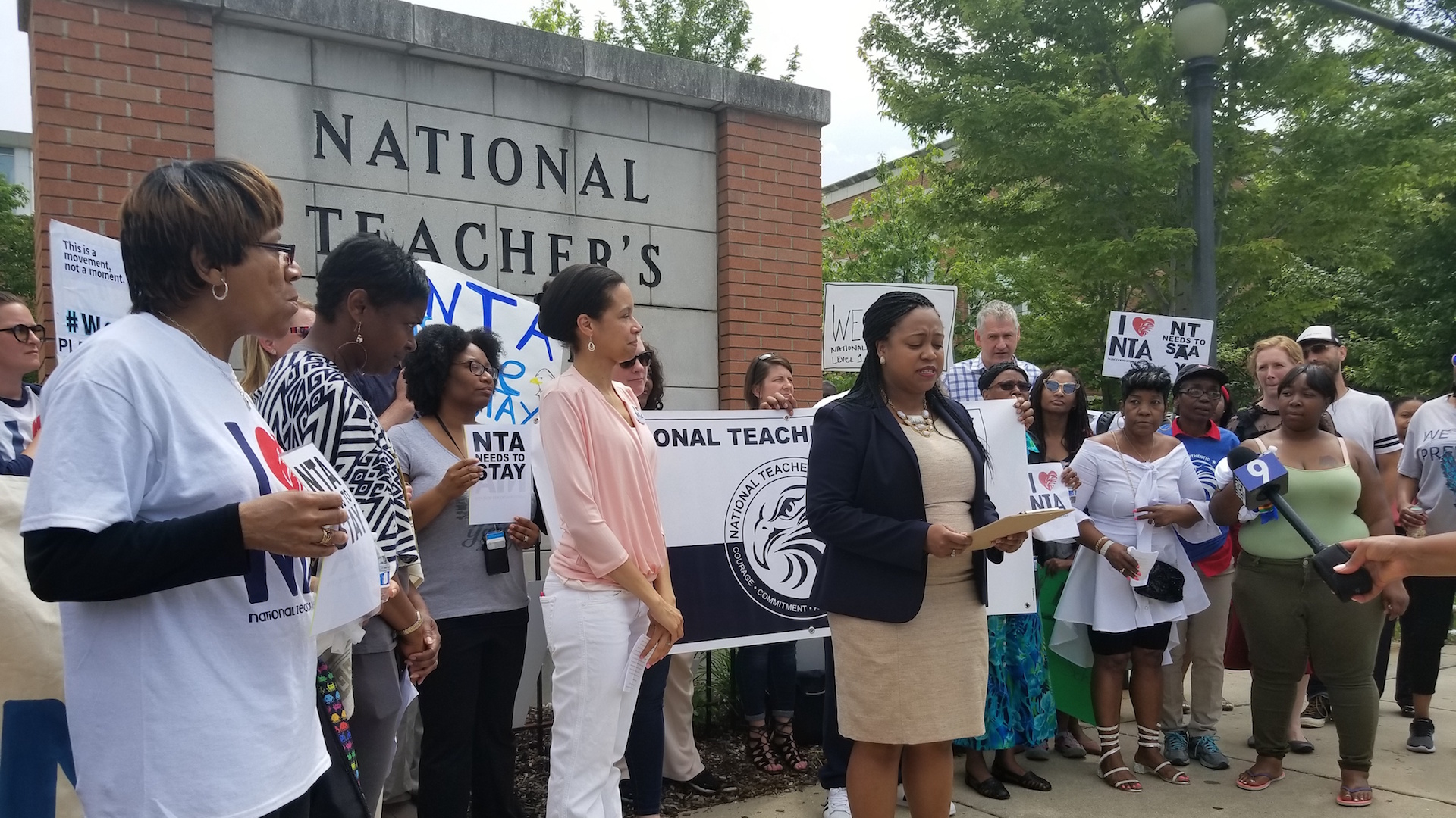 National Teachers Academy parent Elisabeth Greer, center, and Candace Moore, right, of the Chicago Lawyers’ Committee for Civil Rights, discuss their lawsuit outside the school on June 19. 2018. (Matt Masterson / Chicago Tonight)