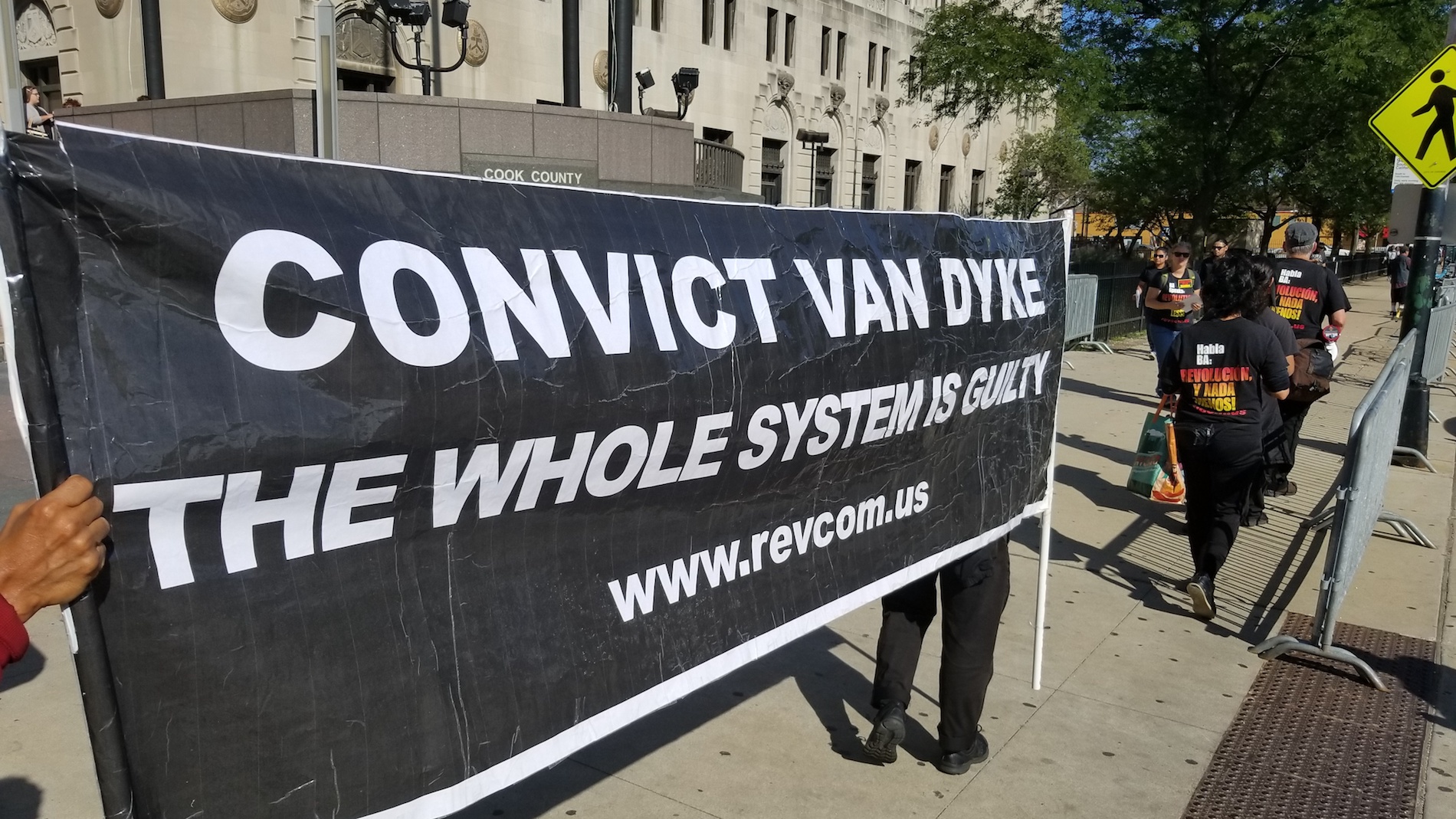 Protesters stand outside the Leighton Criminal Court building on Monday, Sept. 10, 2018 -- the first day of jury selection in Jason Van Dyke’s murder trial. (Matt Masterson / Chicago Tonight)