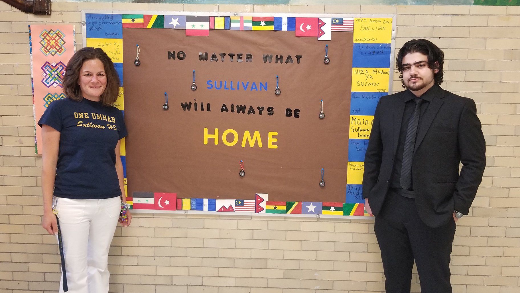 Alaaulldin Al Ibrahim and Sarah Quintenz inside Roger C. Sullivan High School (Matt Masterson / WTTW News)