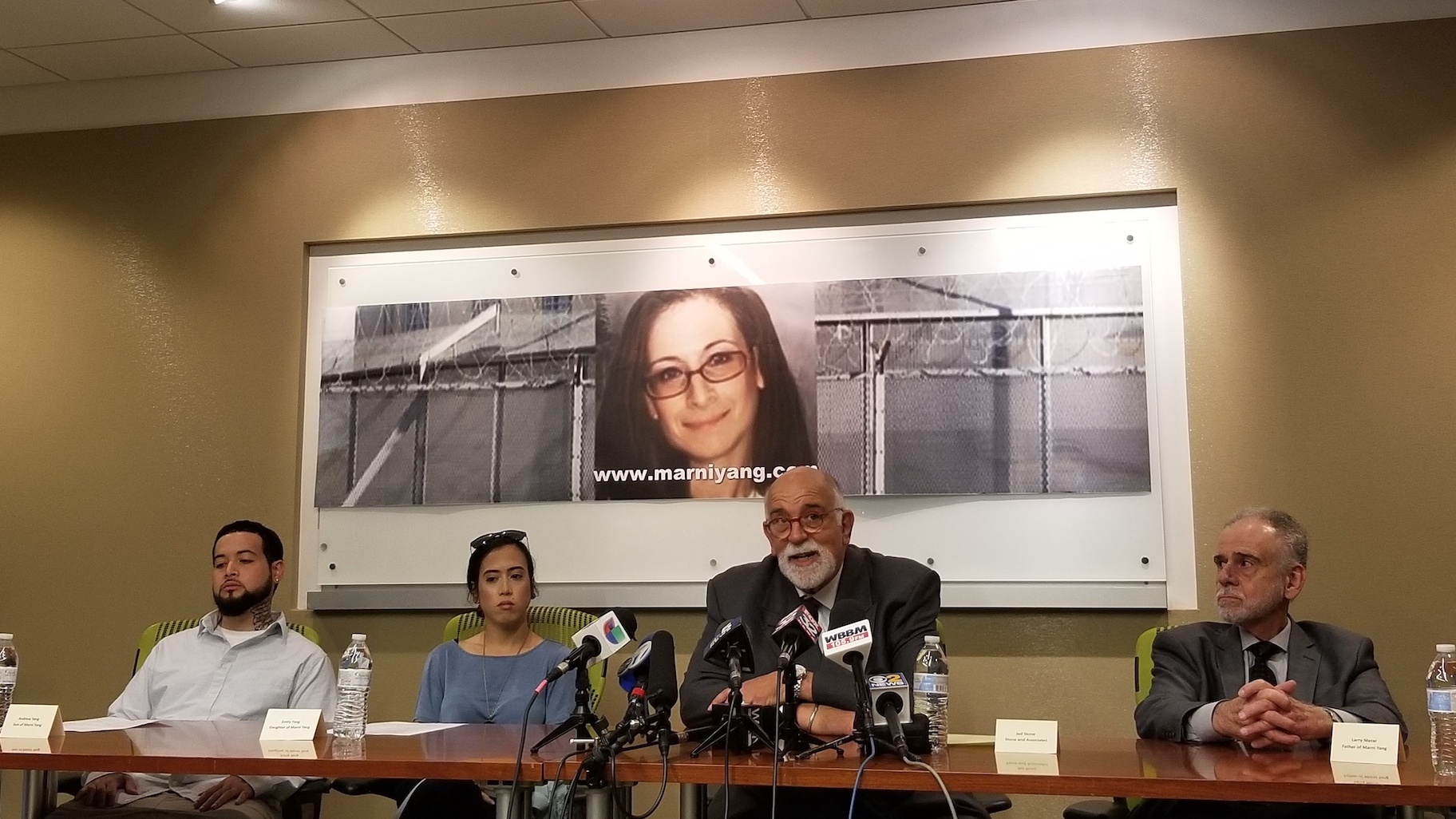 Attorney Jed Stone, center, speaks during a news conference Wednesday discussing his new petition for Marni Yang's freedom. He is surrounded by Yang's children, left, Andrew and Emily, and her father Larry Merar. (Matt Masterson / WTTW News)