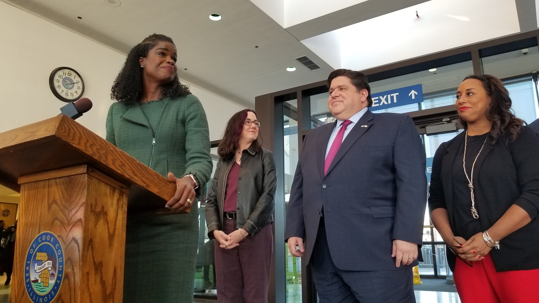 Cook County State’s Attorney Kim Foxx, left, stands beside Gov. J.B. Pritzker inside the lobby of the Leighton Criminal Court Building on Wednesday, Dec. 11, 2019. (Matt Masterson / WTTW News)