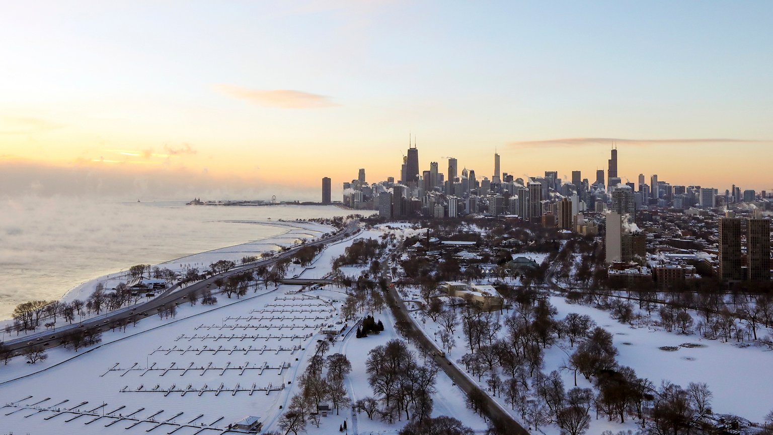 Chicago's lakefront is covered with ice on Wednesday, Jan. 30, 2019. Temperatures are plummeting in Chicago as officials warn against venturing out into the dangerously cold weather. (AP Photo/Teresa Crawford)