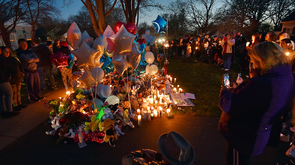 In this Wednesday, April 24, 2019 photo, community members in Crystal lake, Illinois hold a vigil in memory of 5-year-old Andrew “AJ” Freund. Authorities searching for the missing boy who had lived in deplorable conditions dug up his body Wednesday and charged his parents with murder, sadly declaring that the youngster would “no longer have to suffer.” (John Starks/Daily Herald via AP)