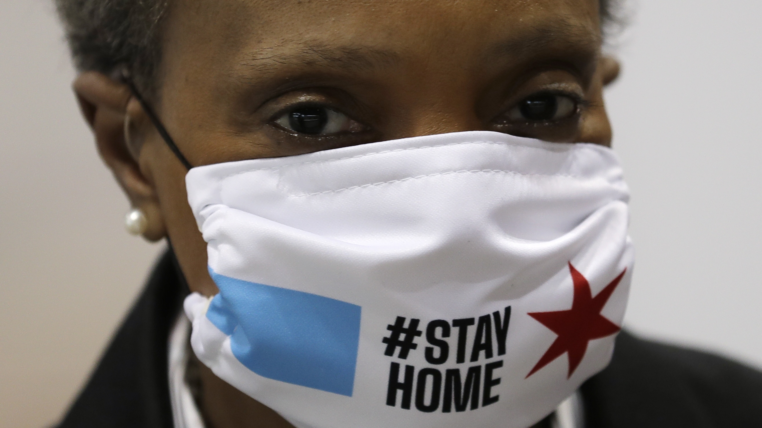 Chicago Mayor Lori Lightfoot wears a mask as she attends a news conference in Hall A of the COVID-19 alternate site at McCormick Place in Chicago, Friday, April 10, 2020. The "alternative care facility" is designed to relieve pressure on city hospitals from rapidly mounting COVID-19 cases. (AP Photo/Nam Y. Huh)