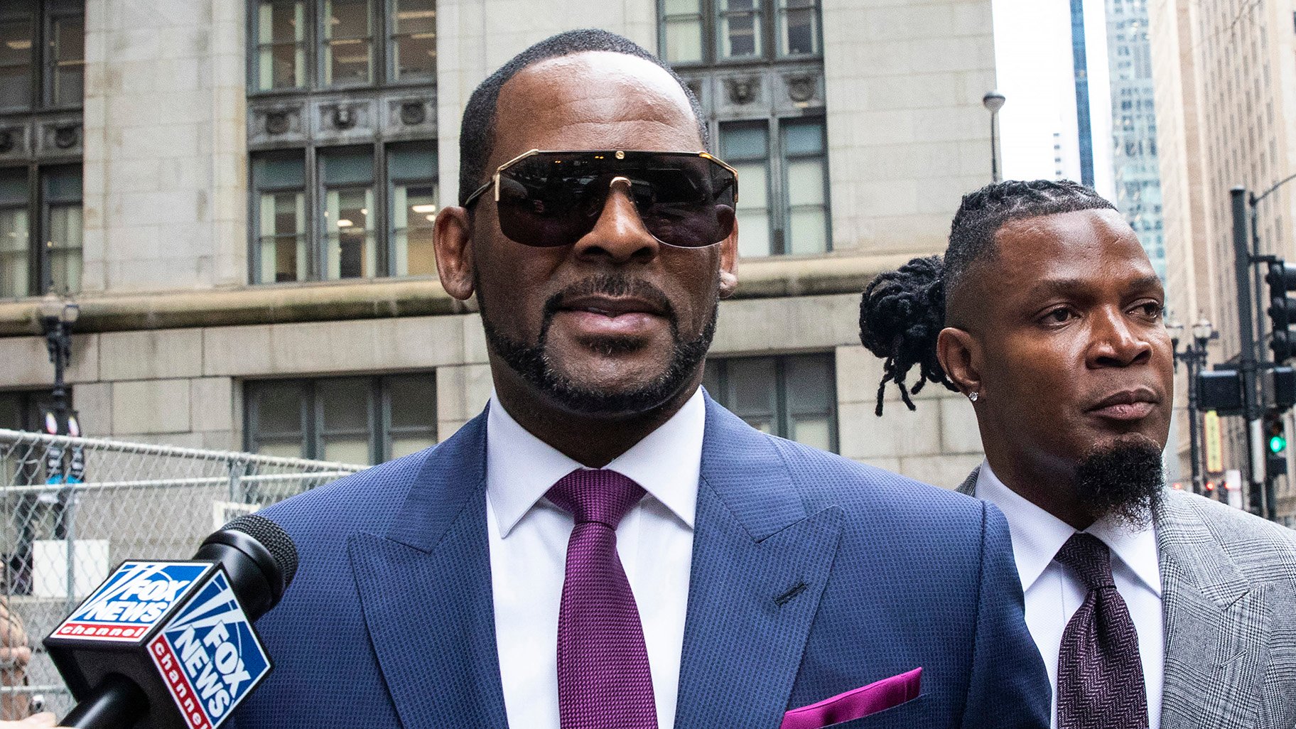 R. Kelly and his publicist Darryll Johnson, right, leave The Daley Center after an appearance in court for Kelly’s child support case on Wednesday, March 13, 2019. (Ashlee Rezin / Chicago Sun-Times via AP)