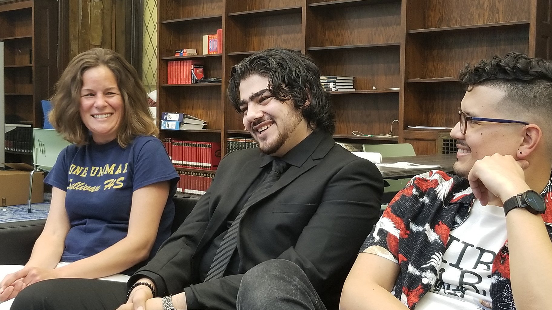 Alaaulldin Al Ibrahim, center, will attend UIC this fall on a full scholarship to study pre-med. Also pictured: Sarah Quintenz, left, and Joshua Zepeda. (Matt Masterson / WTTW News)