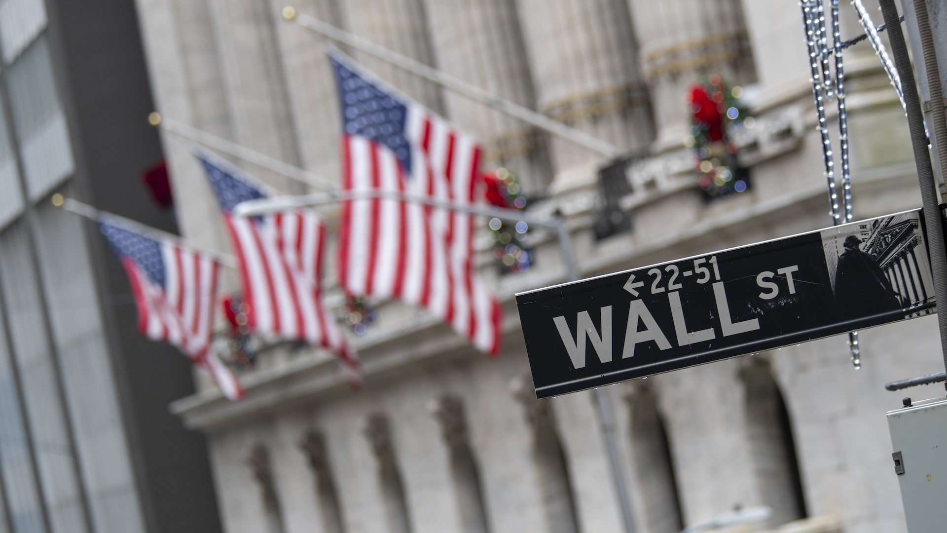 In this Jan. 3, 2020 file photo, the Wall St. street sign is framed by American flags flying outside the New York Stock Exchange in New York. Stocks are falling early on Wall Street Thursday, Sept. 17, as the late selling from the previous day carries over. (AP Photo/Mary Altaffer, File)