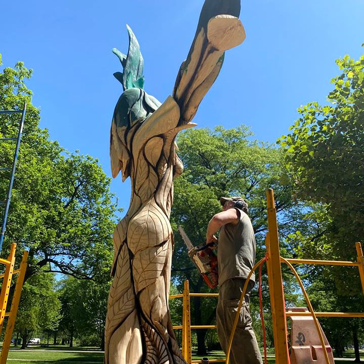 Sculptor Gary Keenan at work on “Green Lady.” Keenan, who lives in Des Moines, Iowa, stayed in Evanston while working on the carving. He had been dreading the commute to Jackson Park — "In Iowa if you drive for an hour, you can go 70 miles," he said — but due to the COVID-19 pandemic, traffic was minimal. The biggest challenge turned out to be finding any place open for carryout at the end of a long day of carving. "I had to do fast food drive thru most of the time," he said. (Chicago Sculpture Internationa