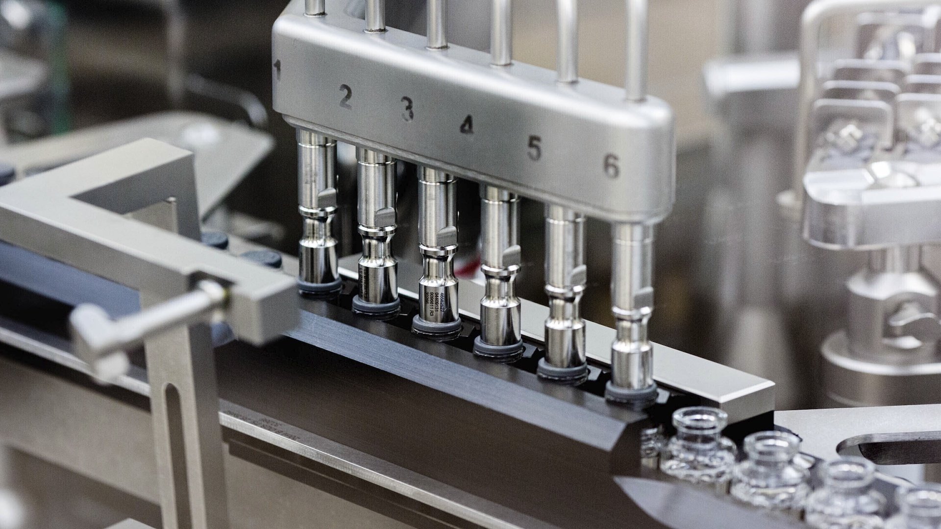 In this March 2020 photo provided by Gilead Sciences, rubber stoppers are placed onto filled vials of the investigational drug remdesivir at a Gilead manufacturing site in the United States. (Gilead Sciences via AP)