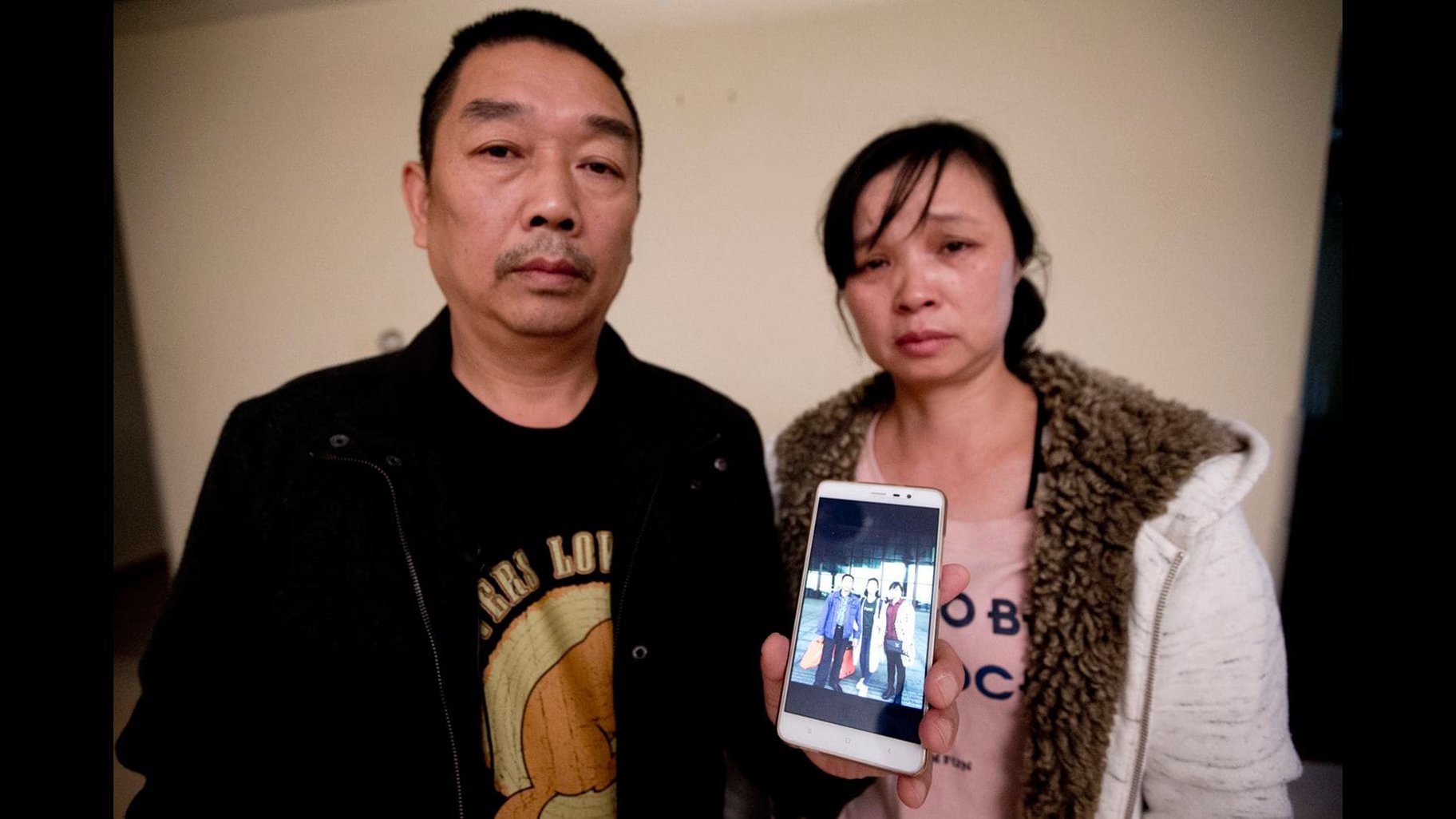 Ronggao Zhang, left, and Lifeng Ye display a photo of them with their missing daughter, Yingying Zhang, in this Nov. 1, 2017 file photo. They have now returned to Illinois as the trial of the man accused in her disappearance is set to begin June 3, 2019. (Michael Conroy File / Associated Press)