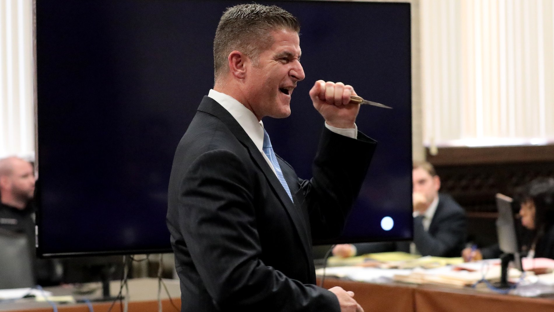 Lead defense attorney Daniel Herbert motions with the 3-inch blade Laquan McDonald carried the night he was fatally shot during opening statements in the trial of Chicago police Officer Jason Van Dyke at the Leighton Criminal Court Building on Sept. 17, 2018. (Antonio Perez / Chicago Tribune / Pool)
