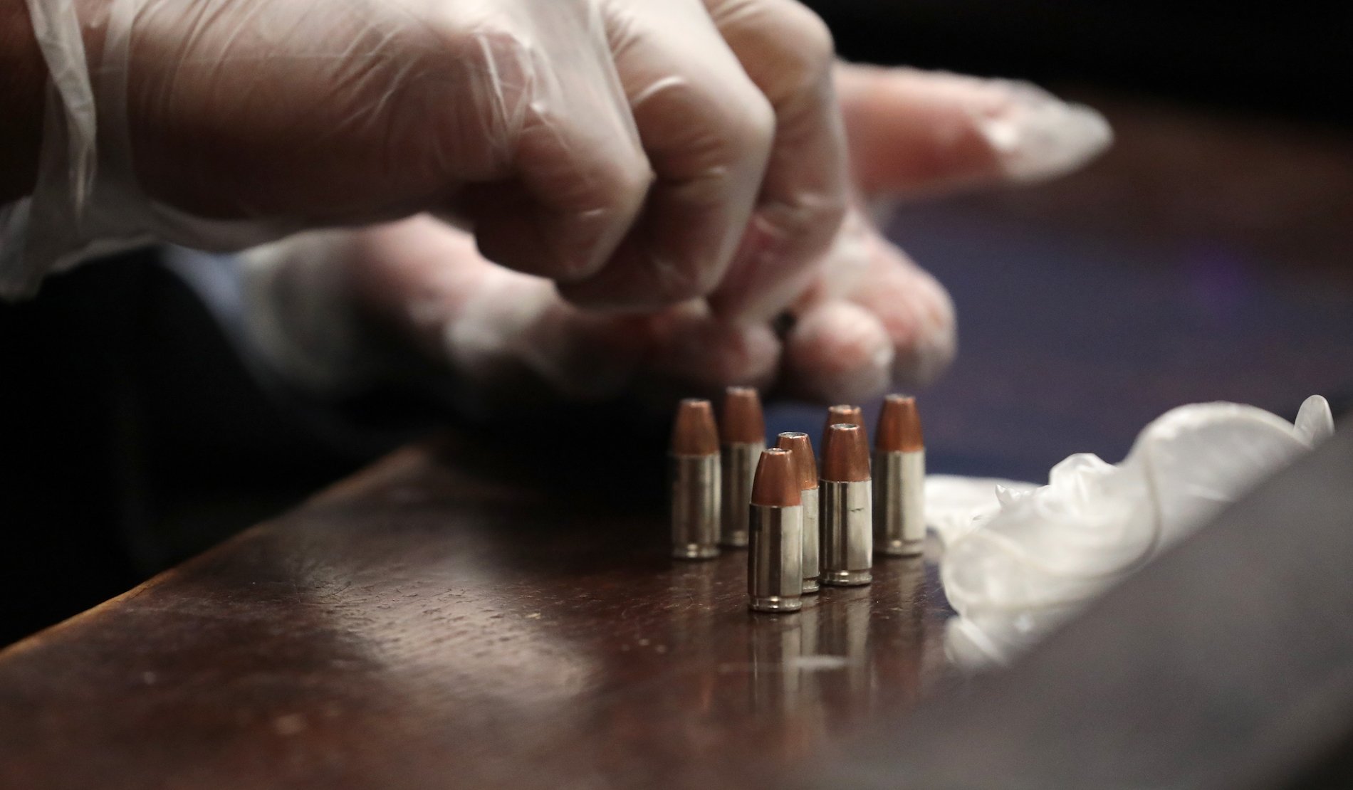 Police Detective Roberto Garcia examines bullets belonging to Chicago police Officer Jason Van Dyke on Tuesday, Sept. 18, 2018. (Antonio Perez / Chicago Tribune / Pool)