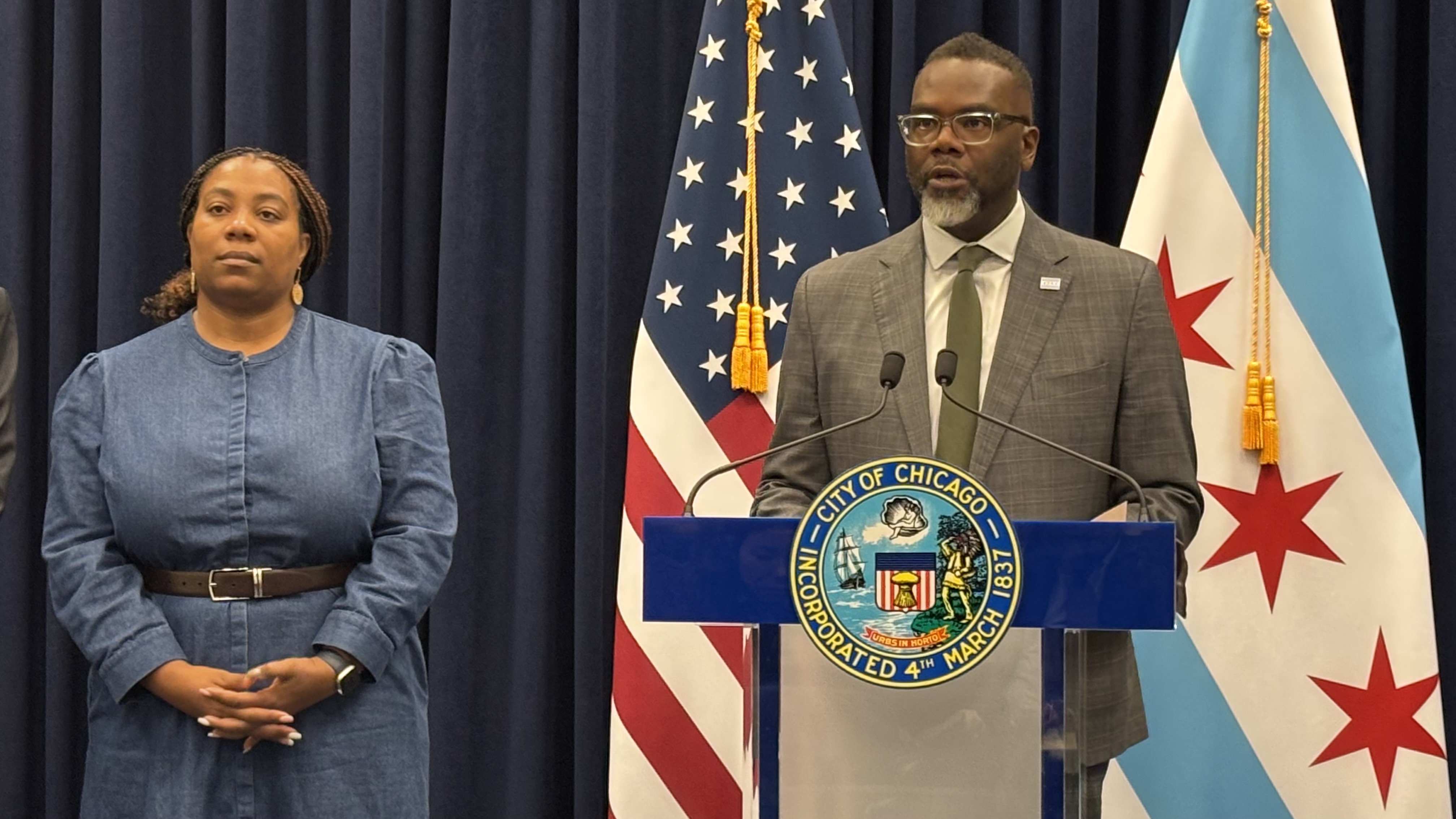 Flanked by Budget Director Annette Guzman, Mayor Brandon Johnson addresses the news media on Monday, Dec. 2, 2024. (Heather Cherone / WTTW News)