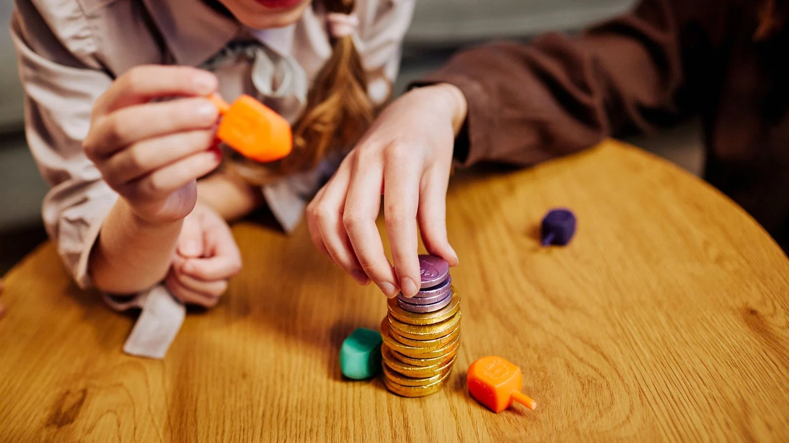 Playing dreidel is one of the many traditions of Hanukkah. (Credit: iStock)