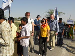 Northwestern University students marching with villagers