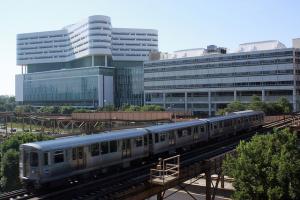 A view near the CTA Pink Line heading north by Rush University Medical Center. The Tower hospital is on the left, the Atrium on the right. Courtesy of Rush University Medical Center.