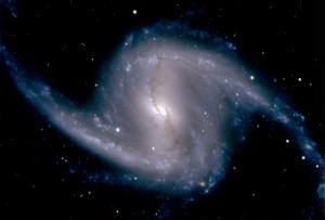 Zoomed-in image from the Dark Energy Camera of the barred spiral galaxy NGC 1365, in the Fornax cluster of galaxies, which lies about 60 million light years from Earth; Photo by Dark Energy Survey Collaboration