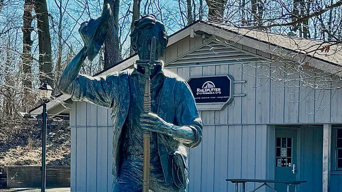 A statue of young Abraham Lincoln stands outside the gift shop and concessions building at the New Salem Historic Site in Petersburg. (Athan Yanos / Medill Illinois News Bureau)