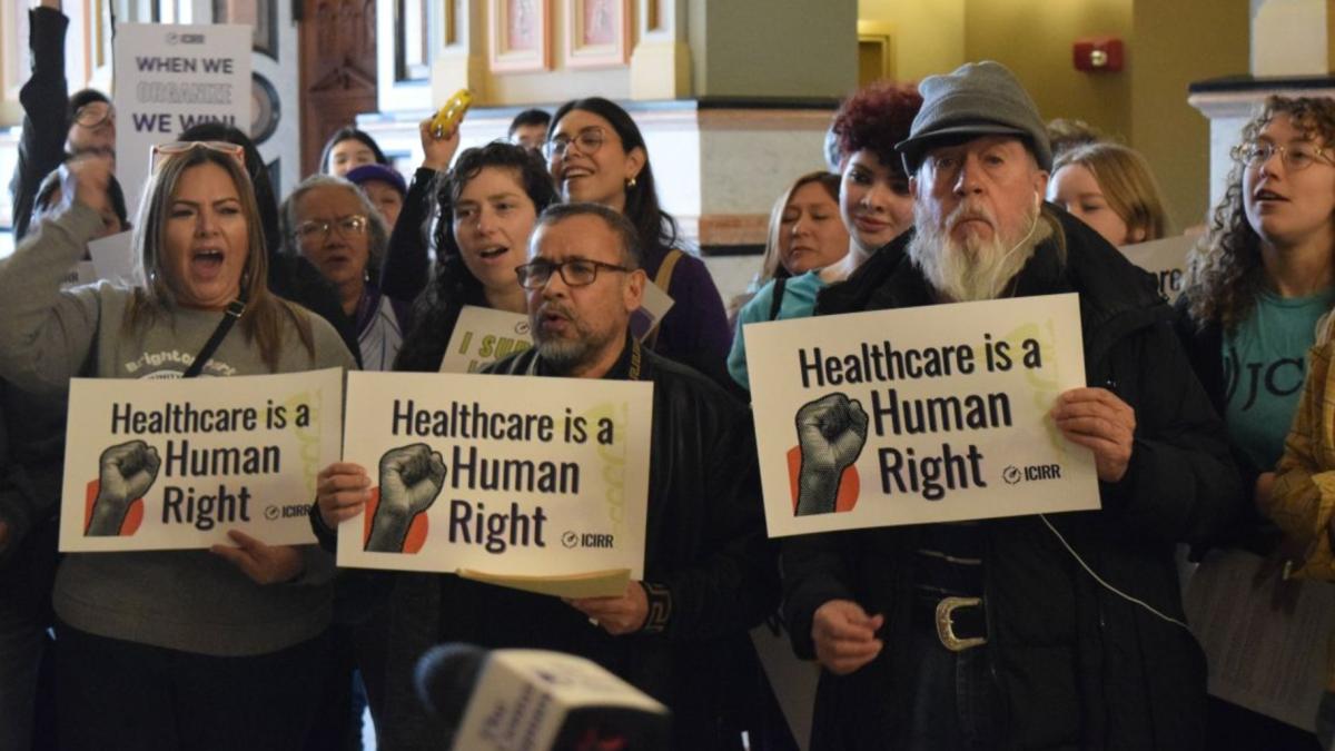 A crowd gathers at the Illinois Capitol in February 2025 to urge state lawmakers to continue to support pro-immigrant policies, including Illinois’ programs for noncitizen health care. (Jade Aubrey / Capitol News Illinois)