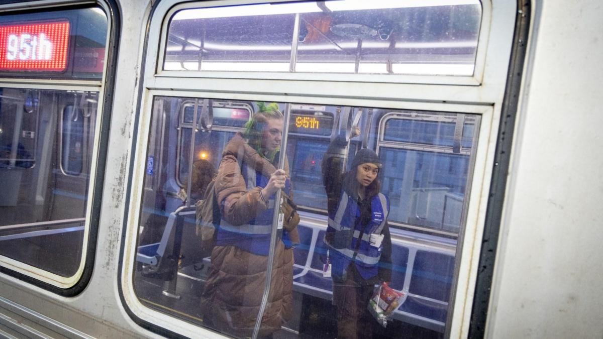 Caseworkers Ell Fabricius (left) and MG Hibionada perform outreach to ridings using the CTA as a shelter of last resort in a 2024 file photo. (Kathleen Hinkel / Block Club Chicago)