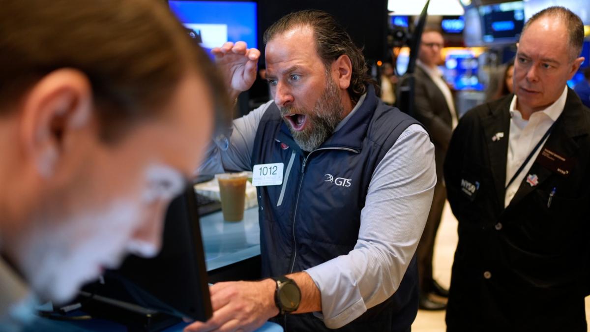 Mike Pistillo Jr., center, works with other traders on the floor at the New York Stock Exchange in New York, Thursday, April 3, 2025. (AP Photo / Seth Wenig)