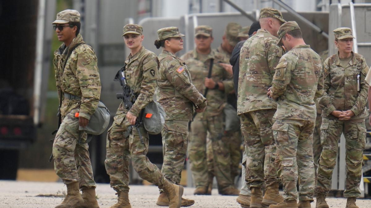 Military personnel in uniform, with the Texas National Guard patch on, are seen at the U.S. Army Reserve Center, Tuesday, Oct. 7, 2025, in Elwood, Ill., a suburb of Chicago. (AP Photo/Erin Hooley)