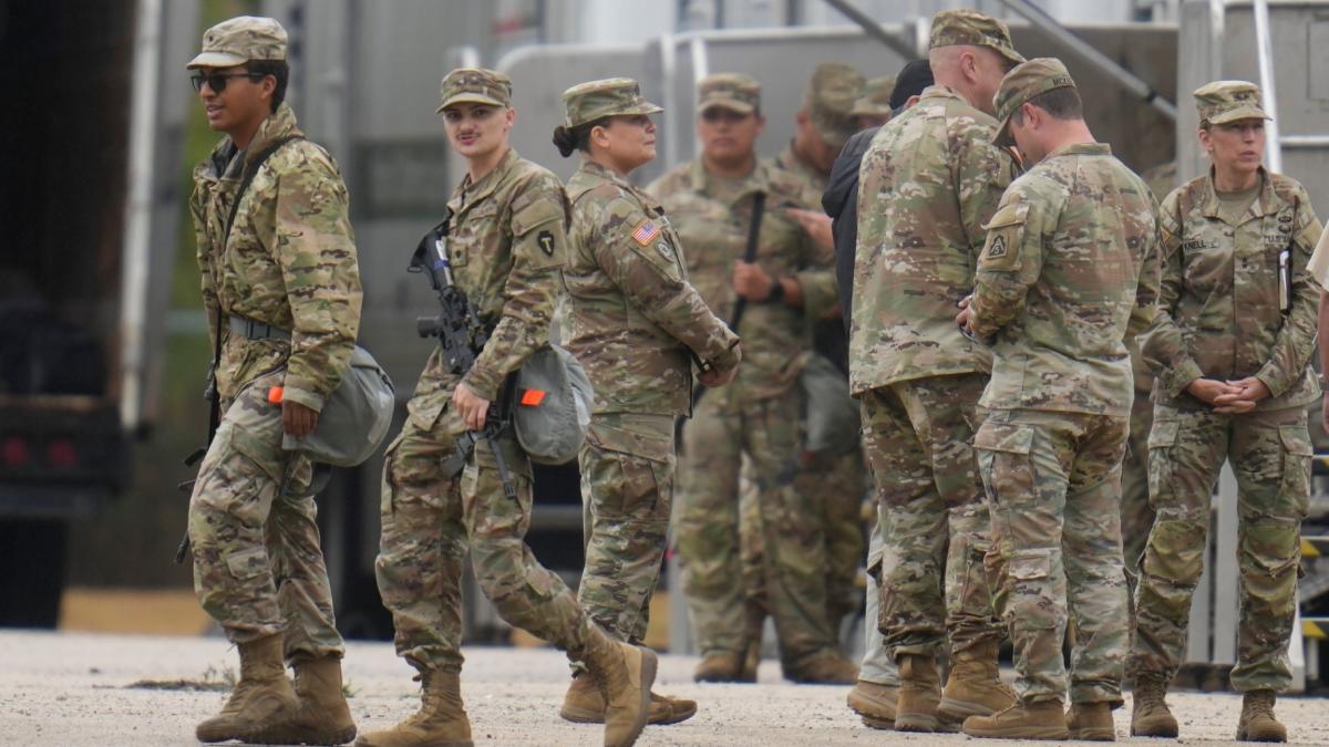 Military personnel in uniform, with the Texas National Guard patch on, are seen at the U.S. Army Reserve Center, Tuesday, Oct. 7, 2025, in Elwood, Ill., a suburb of Chicago. (AP Photo/Erin Hooley)