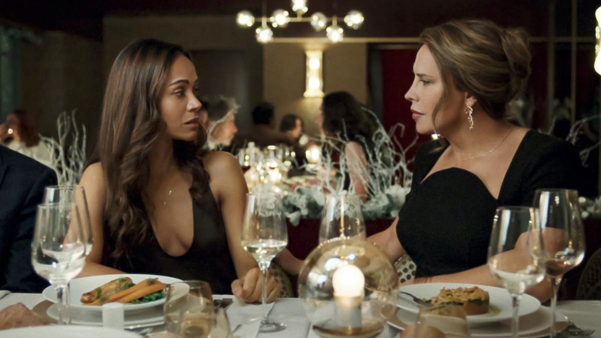This image released by Netflix shows Karla Sofía Gascón, right, and Zoe Saldaña in a scene from "Emilia Pérez." (Shanna Besson/Netflix via AP)