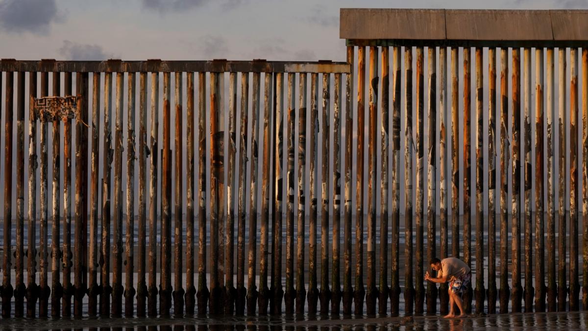 A man takes an image with his phone next to where the border wall separating Mexico and the United States reaches the Pacific Ocean Jan. 28, 2025, in Tijuana, Mexico. (AP Photo / Gregory Bull, File)