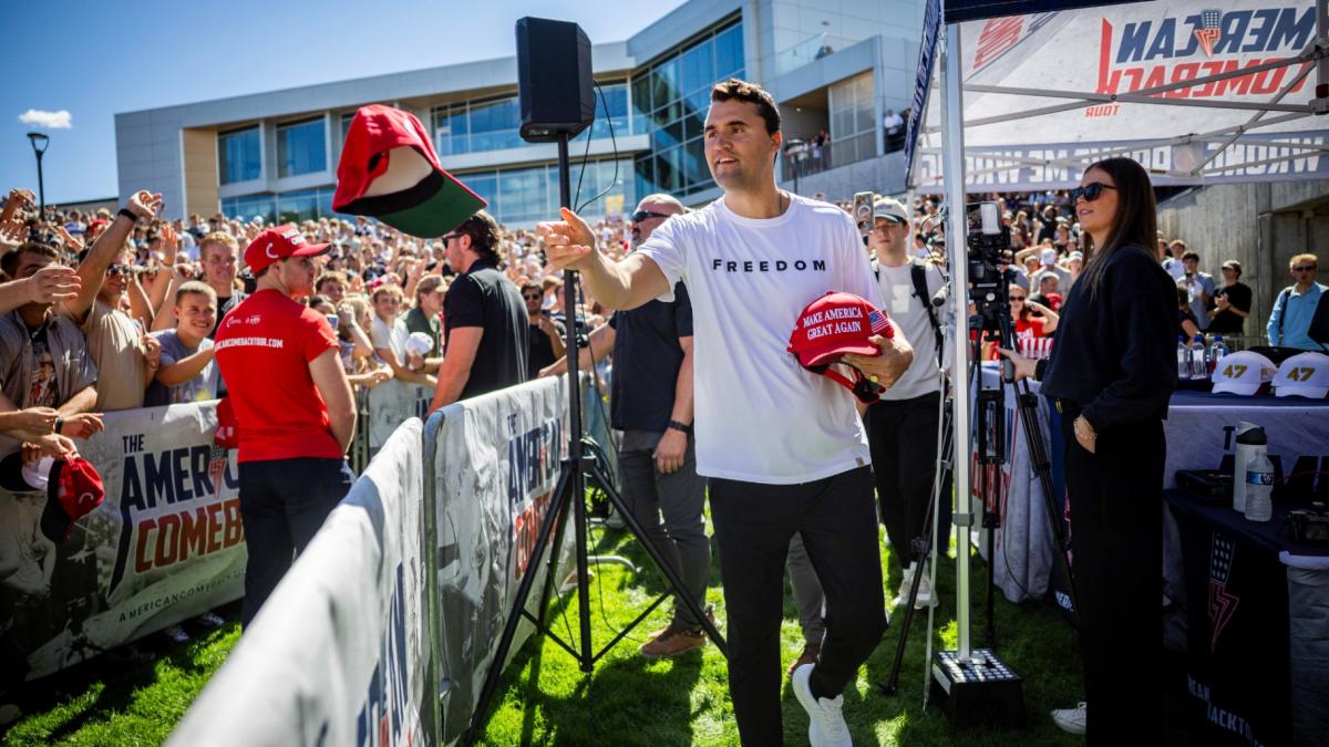 Charlie Kirk hands out hats before speaking at Utah Valley University in Orem, Utah, Wednesday, Sept. 10, 2025. (Tess Crowley/The Deseret News via AP)