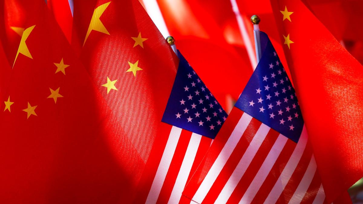 American flags are displayed together with Chinese flags on top of a trishaw on Sept. 16, 2018, in Beijing. (AP Photo / Andy Wong, File)