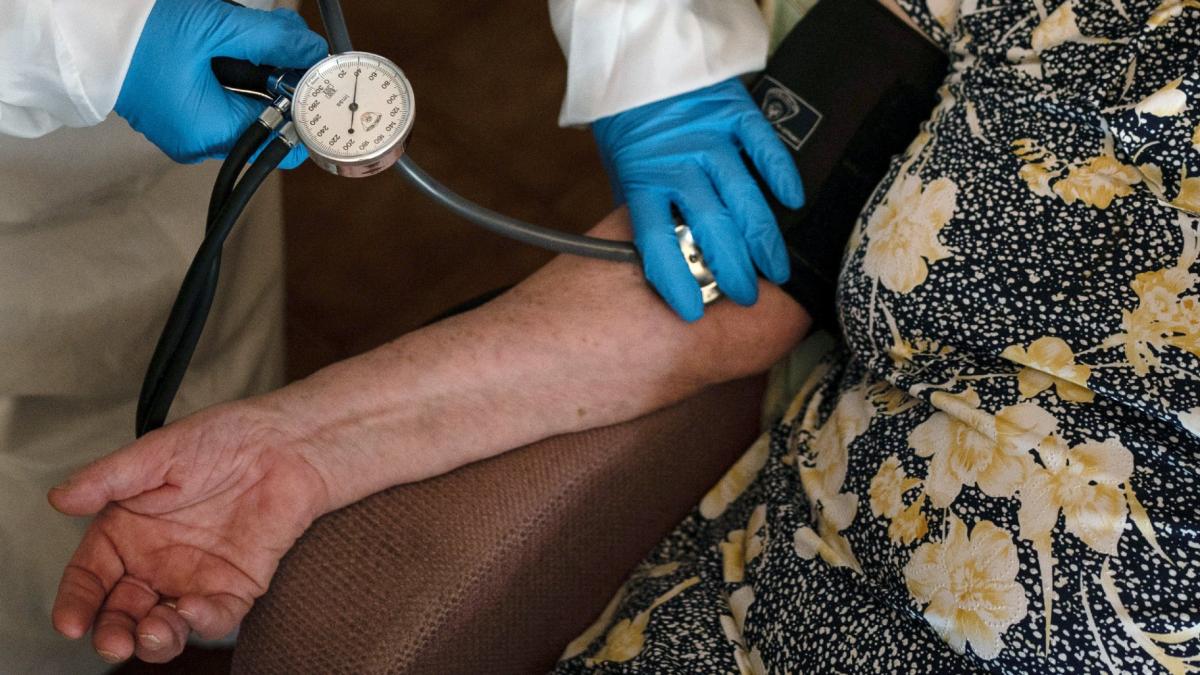 FILE - A doctor checks the blood pressure of A 94-year-old woman in Sant Sadurní d’Anoia, Catalonia region, Spain, Friday, July 31, 2020. (Felipe Dana / AP Photo, File)