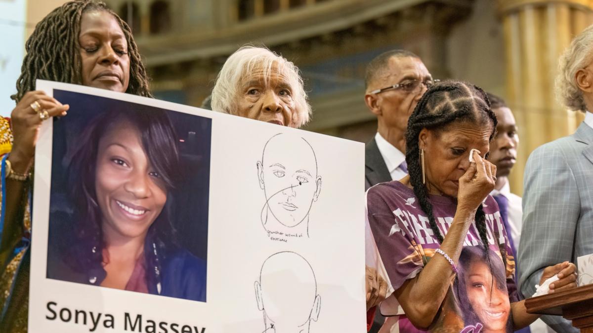 Donna Massey, center right, wipes tears from her face as she listens to Rev. Al Sharpton, right, speak during a press conference over the shooting death of her daughter, Sonya, who was killed by Illinois sheriff's deputy Sean Grayson, at New Mount Pilgrim Church in Chicago, July 30, 2024. (Tyler Pasciak LaRiviere / Chicago Sun-Times via AP, File)