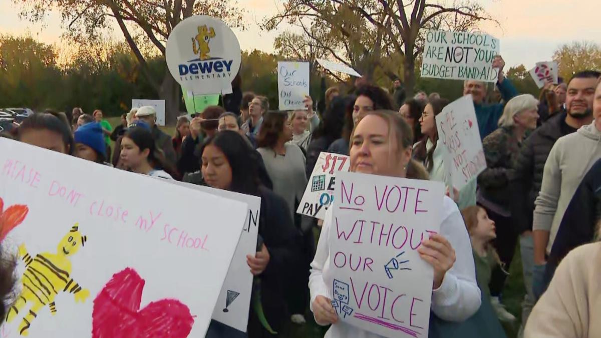 Families protest the proposed closures of two Evanston elementary schools, Oct. 26, 2026. (WTTW News)