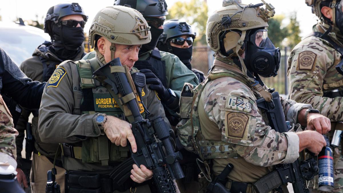 Border Patrol chief Gregory Bovino stands with federal immigration enforcement agents during a skirmish with protesters in Little Village neighborhood, Chicago Thursday, Oct. 23, 2025. (Anthony Vazquez / Chicago Sun-Times via AP)