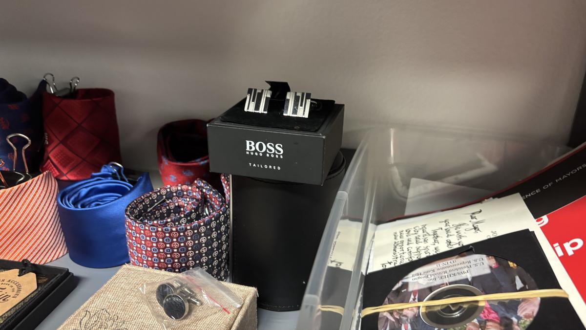 A shelf in the mayor's gift room that includes a pair of Hugo Boss cuff links accepted by Mayor Brandon Johnson's office on behalf of the city of Chicago. (Heather Cherone/WTTW News)