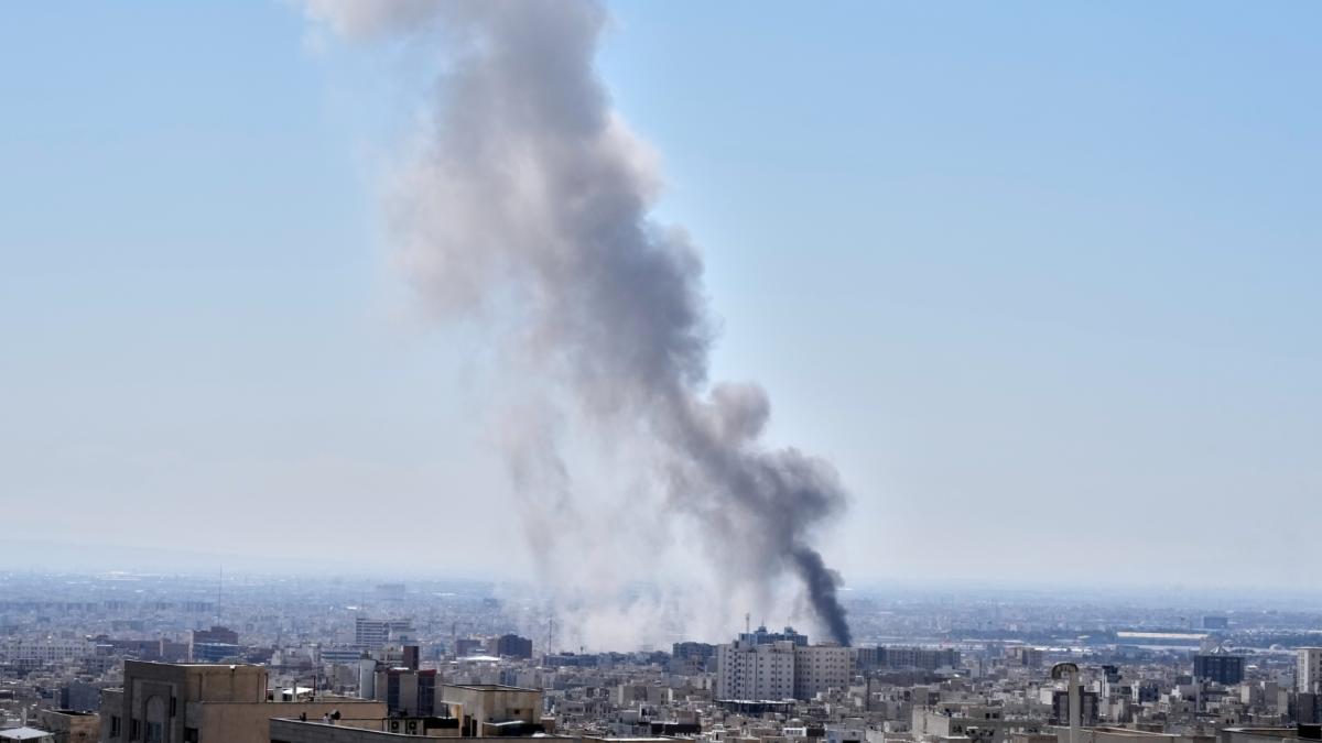 A plume of smoke rises after a strike in Tehran, Iran, Sunday, March 1, 2026. (AP Photo / Vahid Salemi)