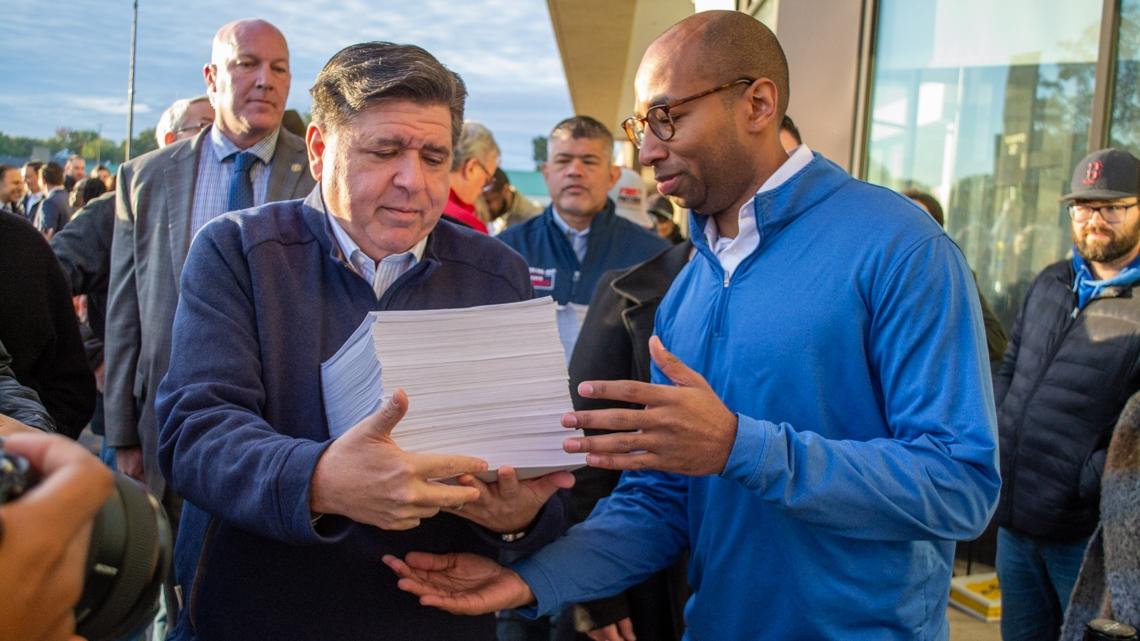 Gov. JB Pritzker and lieutenant governor candidate Christian Mitchell prepare to file nominating petitions at the Illinois State Board of Elections building in Springfield on Monday, Oct. 27, 2025. Between them is Cook County Republican Party Chair Aaron Del Mar, who is running for lieutenant governor on the GOP ticket alongside former state Sen. Darren Bailey.  (Jerry Nowicki / Capitol News Illinois)