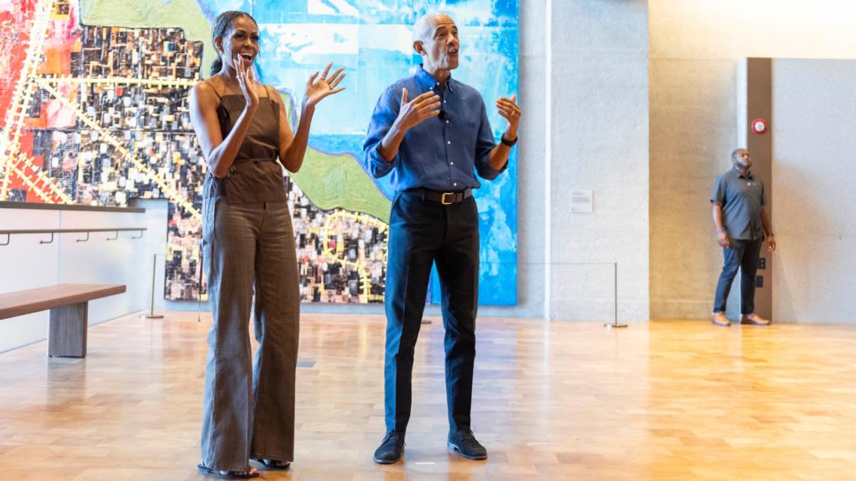 Former President Barack Obama and former first lady Michelle Obama welcome community members in the Hope and Change lobby before they walk through the museum at the Obama Presidential Center in Chicago on Friday, June 19, 2026. (Eileen T. Meslar / Chicago Tribune via AP, Pool)